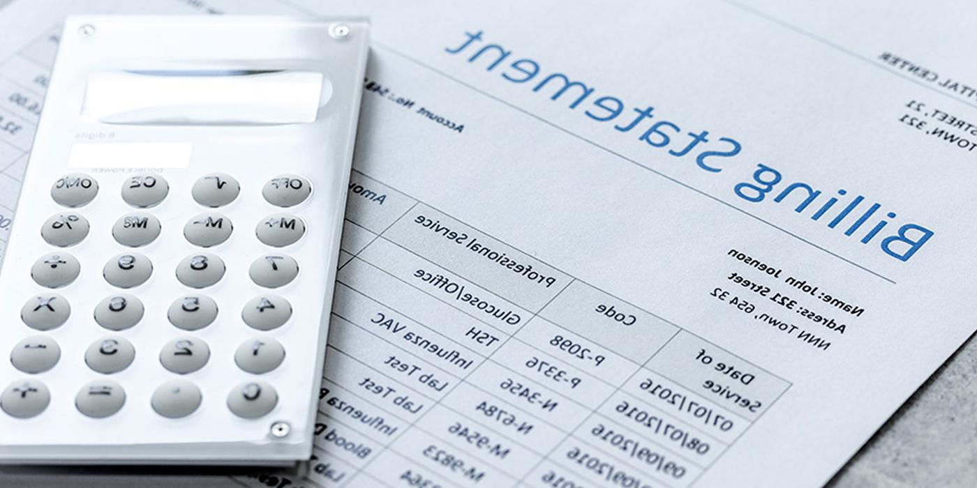 A calculator laying on a billing statement